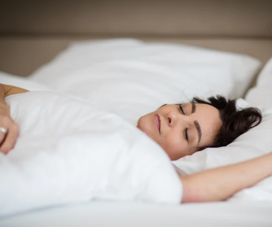 Woman Sleeping in Bed, blog about discussing melatonin