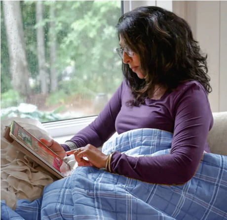 Pregnant woman using SleepGift blanket for comfortable sleep